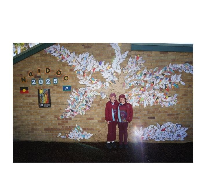 2 students against mural